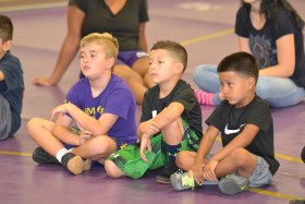A trio of future champs listen intently to Isaiah Martinez during a weekend wrestling camp.